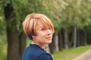 Redheaded older woman with an asymmetrical bob